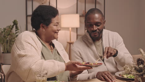 african american family enjoying dinner together