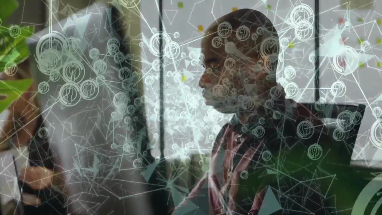 Technology professionals working on computers with animated network overlay highlighting data links
