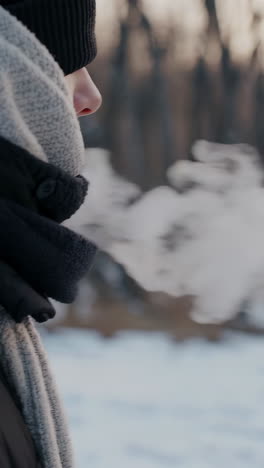 person exhaling in cold winter weather