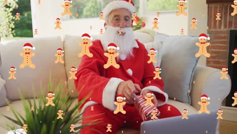 Animation-of-cookies-falling-over-caucasian-man-wearing-santa-costume-having-video-call-at-christmas
