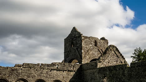 Motion-time-lapse-of-Boyle-Abbey-medieval-ruin-in-county-Roscommon-in-Ireland-as-a-historical-sightseeing-landmark-with-dramatic-clouds-in-the-sky-on-a-summer-day