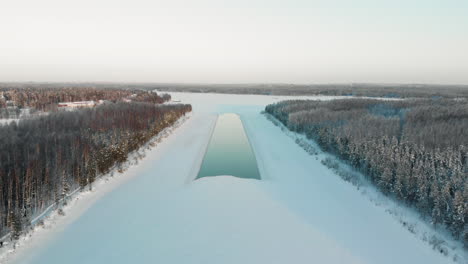 aerial, drone shot, towards a iceless spot, on a river, on a sunny, winter day, in utra, joensuu, north karelia, finland