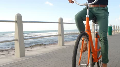 man cycling on the beach 4k