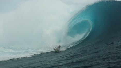 man body surfing a perfect barrel in teahupoo french polynesia tahiti