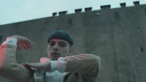 cool male dancer voguing to camera outdoors