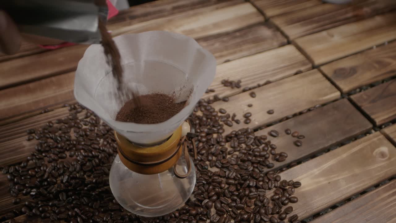 Placing ground coffee in parchment paper inside a container for brewing is a traditional method, adding an artisanal touch to the coffee-making process.