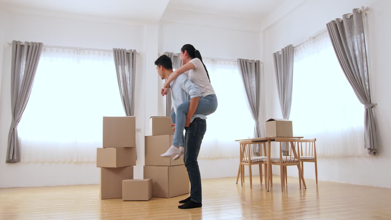 Man Carrying His Lover On Back And Celebrate In New Home