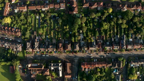 top down aerial shot over english row houses and gardens