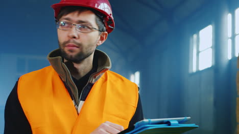 an engineer works in a warehouse and uses a tablet 5