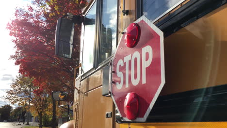 school bus stop sign autumn trees back to school