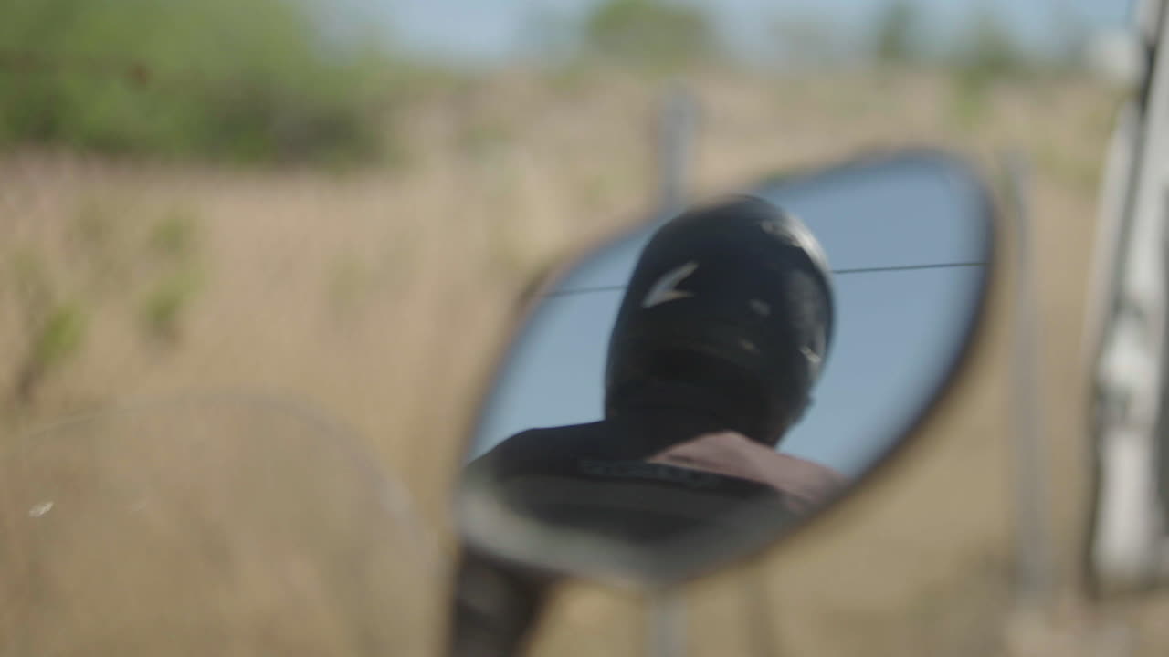 Motorcycle Rider Reflection in Mirror