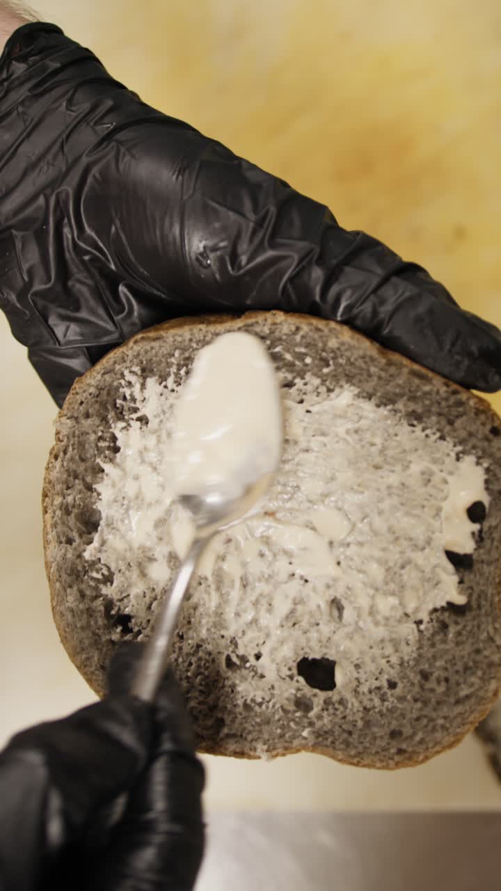 Chef Spreading The Special Mayonnaise On The Bottom Of The Gourmet Burger