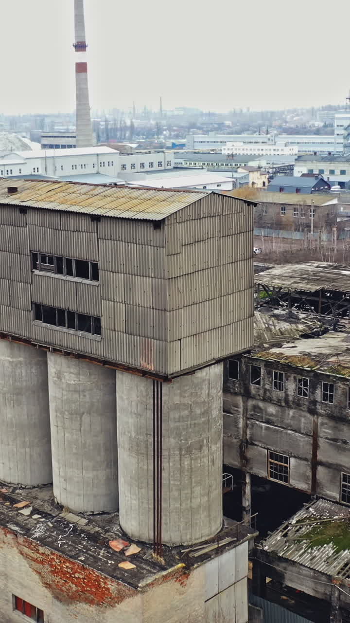 Aerial view of an abandoned industrial plant. Factory ruins. Vertical video