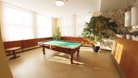 Smooth-motion-revealing-billiard-snooker-pool-table-in-a-hall-with-nobody-around-bright-sunny-indoor-beautiful-to-watch