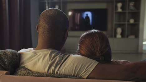 couple watching tv at home