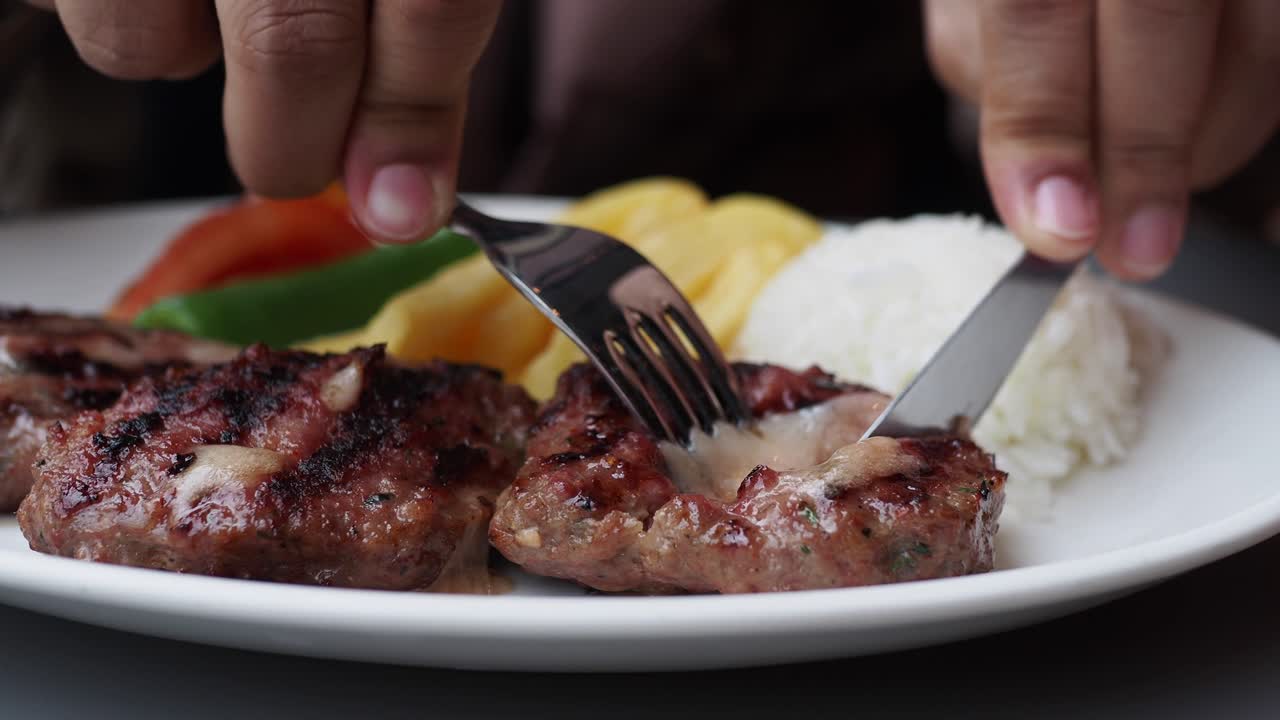 Cutting grilled gourmet meats with knife ,
