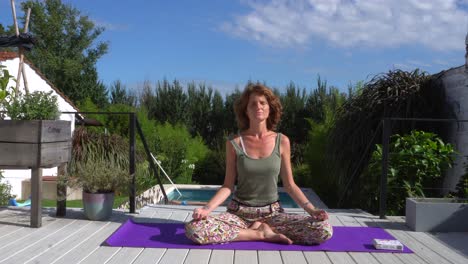 a young caucasian redhead woman practising yoga on a sunny morning