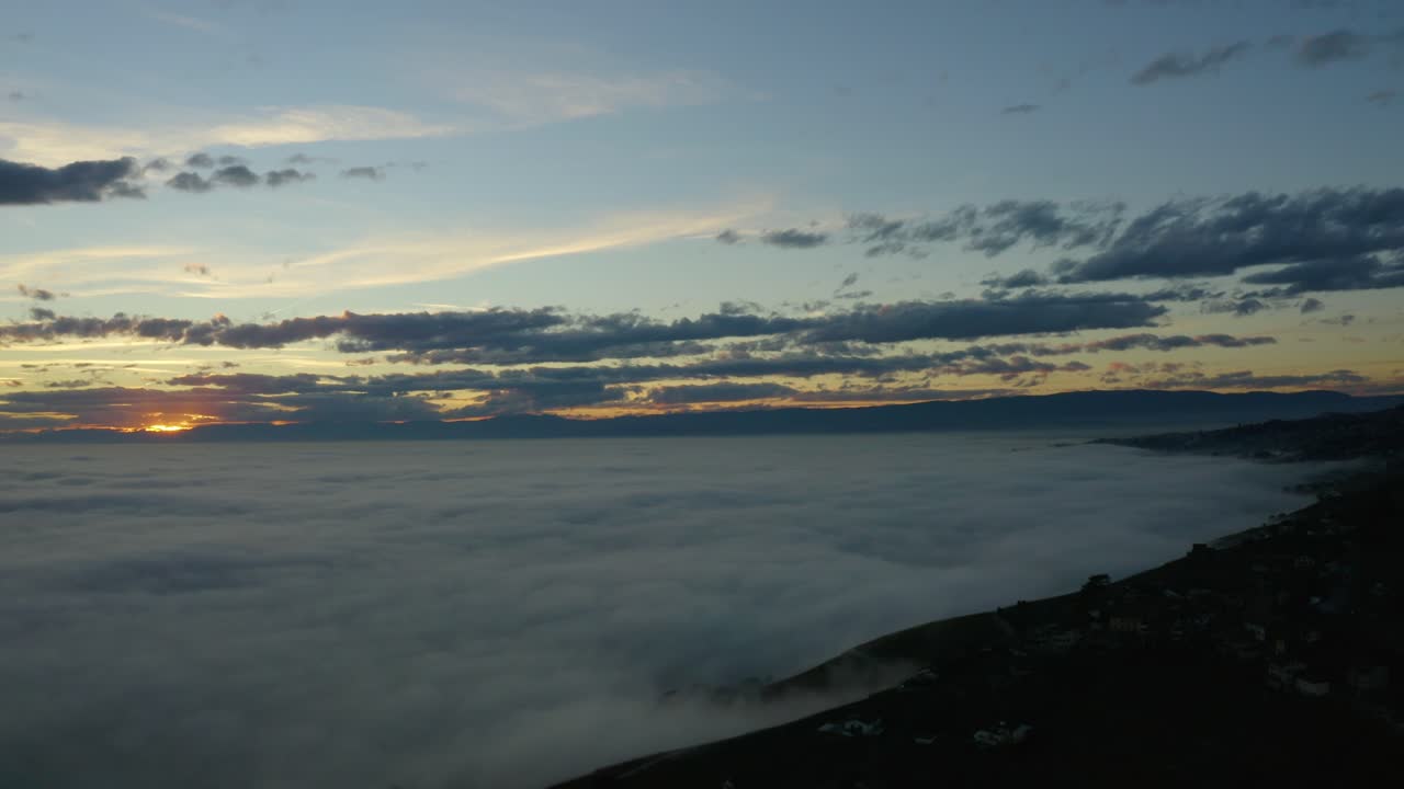 Aerial over sea of fog covering Lake Léman at sunset Lavaux - Switzerland