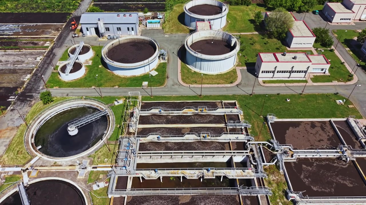 Drone captures treatment plant details. An expansive drone photograph highlights large scale water treatment facility with operational and environmental features