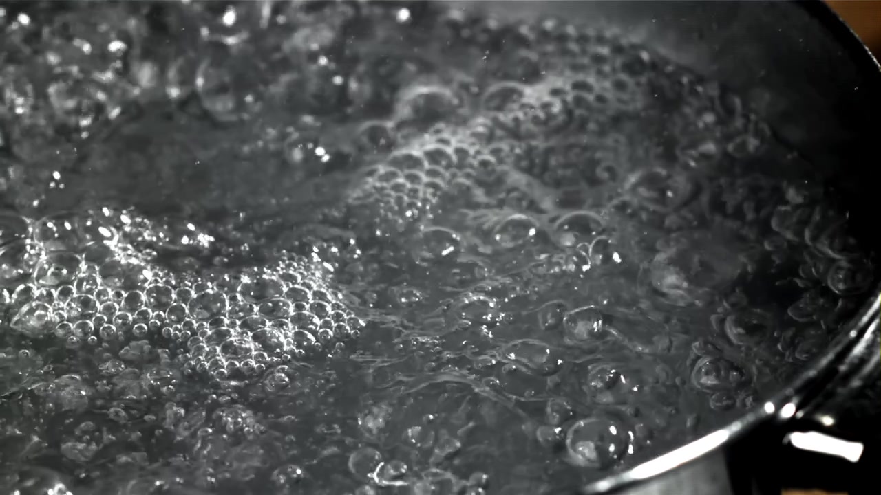 Close-up of Water Boiling with Bubbles in a Pot