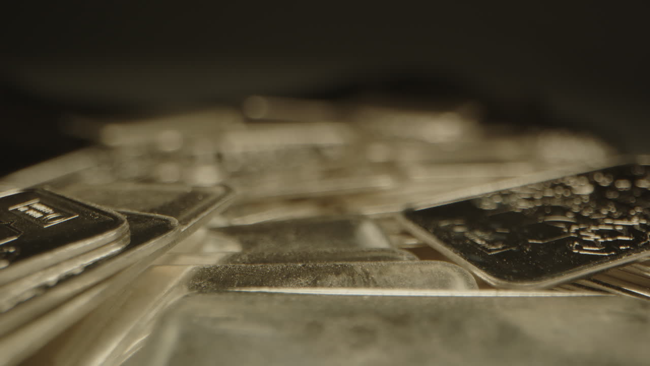 Beautiful macro focus rack of many silver bars lying on a velvet surface