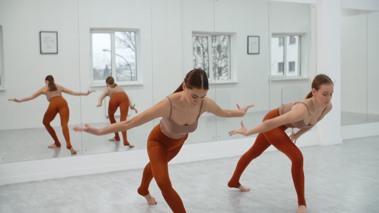 Women practicing contemporary dance in a studio