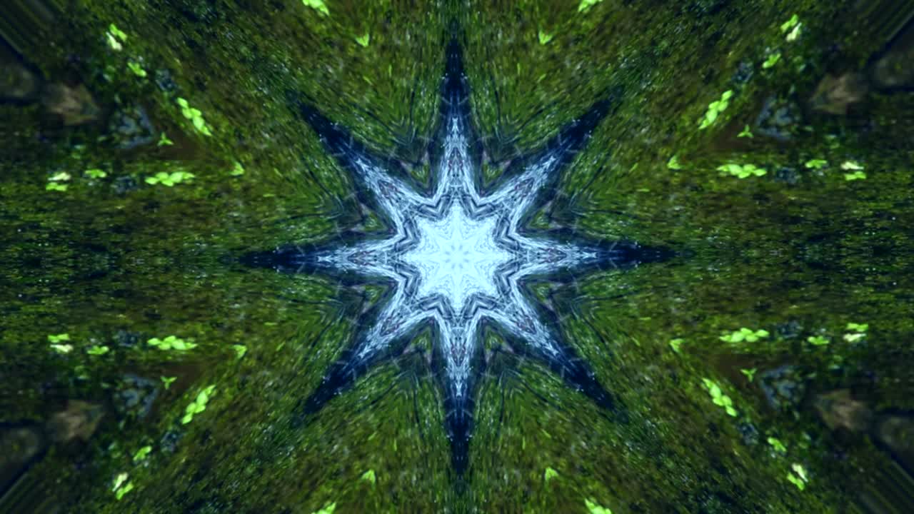 video con forma de mandala girando y cambiando formas con formas de estrellas y ángulos que se abren en las figuras formadas con caleidoscopio con movimiento en colores verde y azul