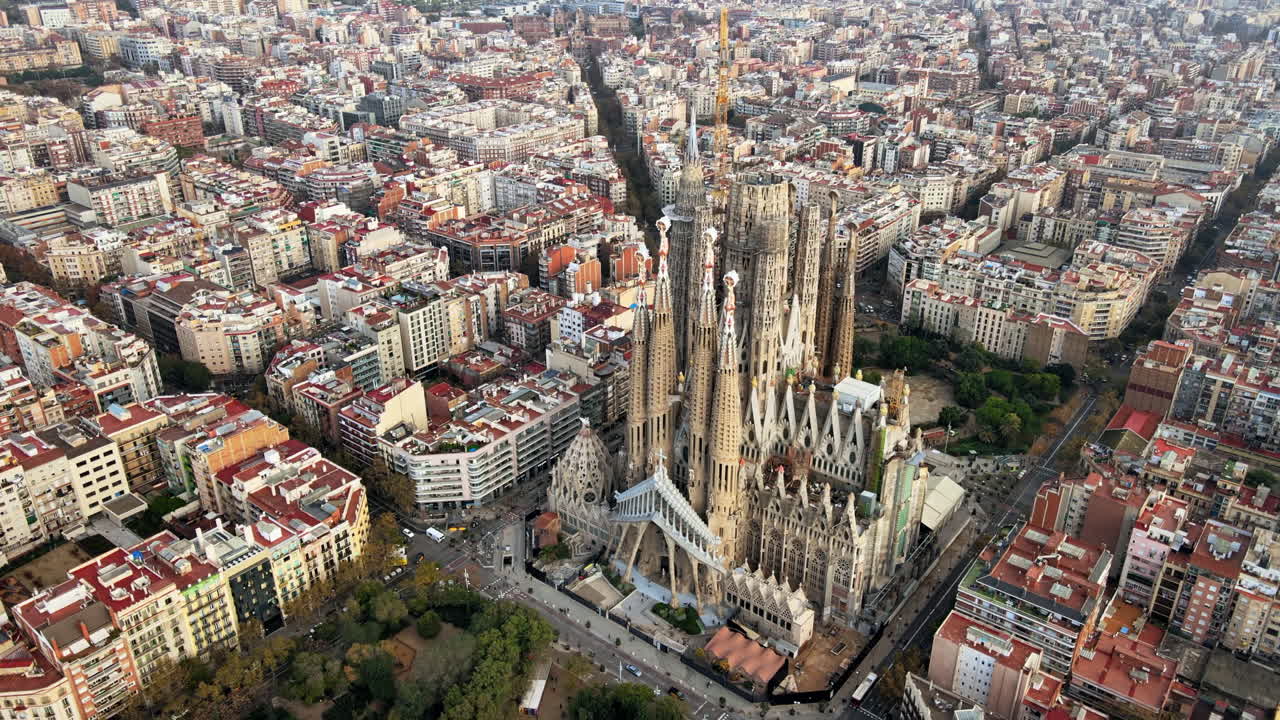 Aerial drone view of Barcelona, Spain. Blocks with multiple residential buildings and Sagrada Familia