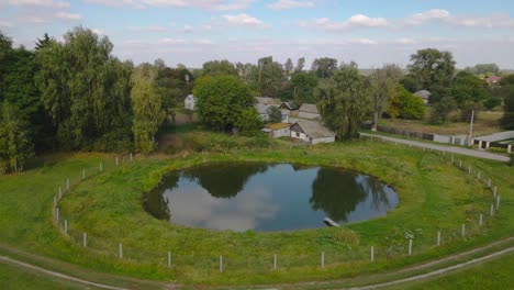 aerial view of a small pond in the village. drone flight, 4k video.