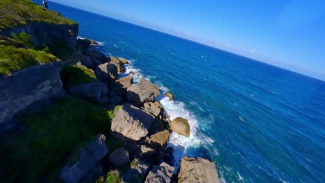 Drone-FPV-along-rocky-coastline-of-Cabo-Frances-Viejo-National-Park,-Caribbean