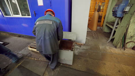 worker performing maintenance in a factory