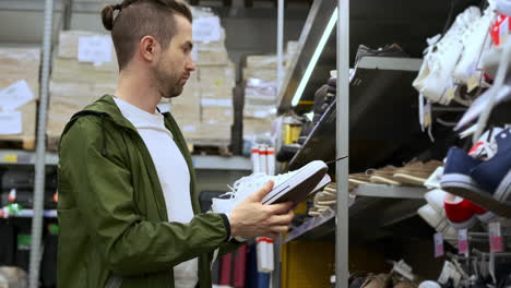 man shopping for shoes in a store