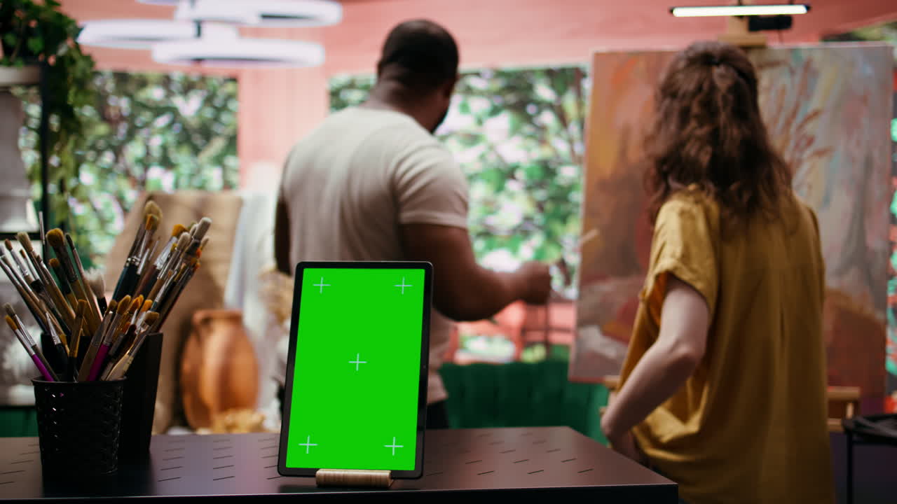 Artisti che dipingono in uno studio d'arte con un tablet