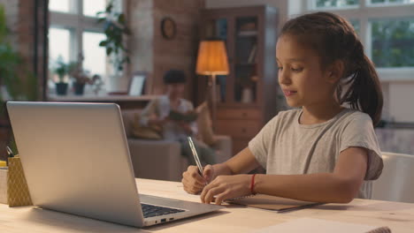 girl doing homework at home