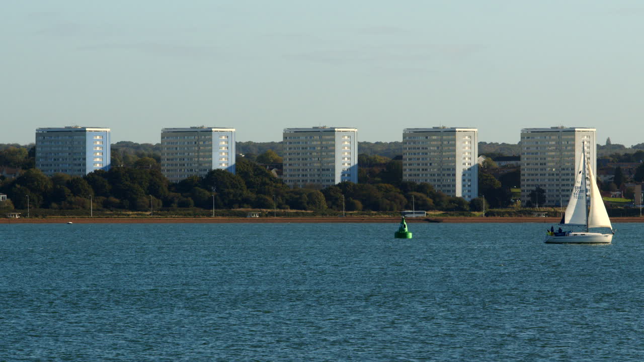 Shot of Weston&rsquo;s tower blocks on international way taken from Hythe Marina with sailboat in foreground
