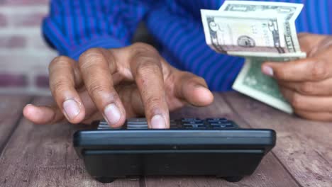 person counting money with a calculator