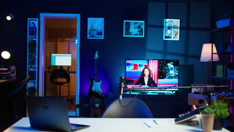 streaming equipment in modern apartment illuminated with rgb lights at night