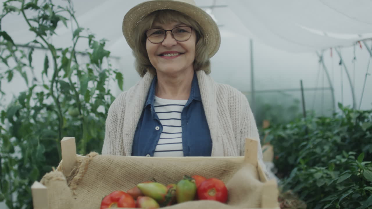 Portrait of Senior Woman with Harvest in Greenhouse
