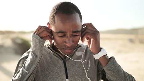 man using earphones on the street