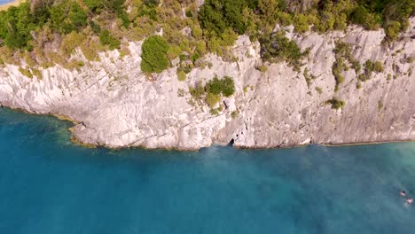 Aerial-shot-of-Xigia-beach-with-turquoise-water-and-white-cliffs-on-Zakynthos-Island