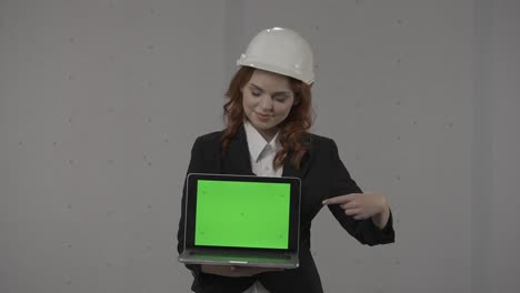 engineer presenting a laptop with a green screen