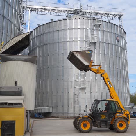 silver silos on agro manufacturing plant for storage of agricultural products. large iron barrels of grain. granary elevator