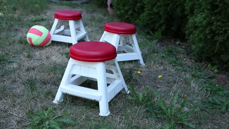 three red chairs in the yard