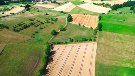 aerial-drone-flight-over-colourful-summer-farmland,-4k