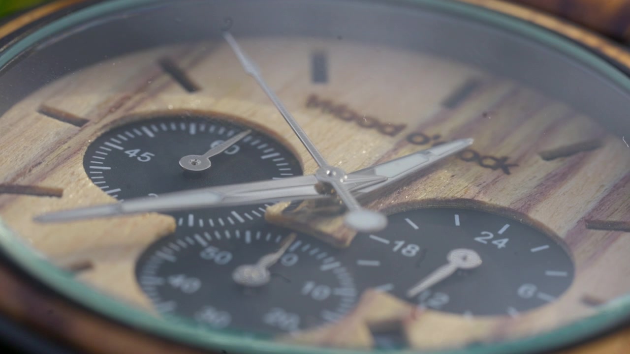 I dettagli intricati di un orologio in legno si rivelano, mostrando un mondo in miniatura di artigianato.