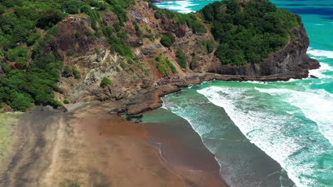 scenic aerial view of te waha point lookout at whites beach in auckland, new zealand - drone pullback