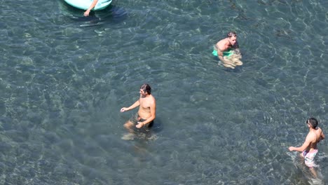two people playing with a ball in water