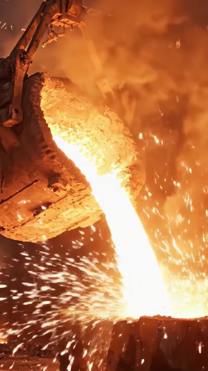 Intense Metal Pouring Process: A Captivating Display of Molten Metal Flowing from Industrial Furnace in a Hot and Fiery Environment