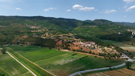 Aerial-view-circling-a-hill-full-of-homes-on-the-rural-Istria,-summer-in-Croatia