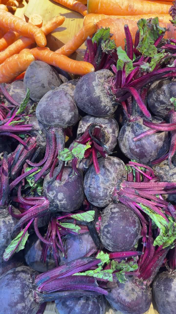 Fresh Beetroots with Stems and Carrots in a Market